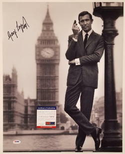 George Lazenby Signed 16x20 James Bond Photo PSA/DNA Authenticated: George Lazenby Signed 16x20 James Bond Photo PSA/DNA Authenticated This stunning 16x20 photograph features George Lazenby, the iconic James Bond, and is signed by the actor himself. The autograph is a