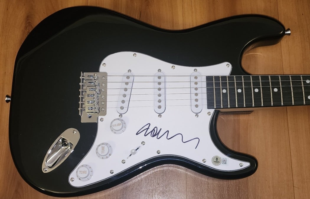 John Taylor Signed Electric Guitar Duran Duran Beckett Authenticated: John Taylor Signed Electric Guitar Duran Duran Beckett Authenticated This is a pre-owned electric guitar autographed by John Taylor, the renowned bassist of Duran Duran. The guitar comes with a Becket