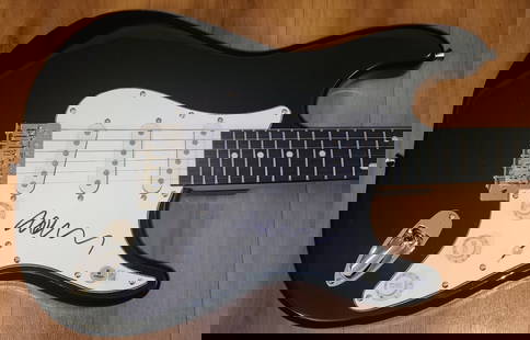John Taylor Signed Electric Guitar Duran Duran Beckett Authenticated: John Taylor Signed Electric Guitar Duran Duran Beckett Authenticated This is a pre-owned electric guitar autographed by John Taylor, the renowned bassist of Duran Duran. The guitar comes with a Becket