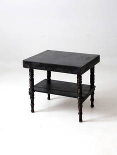 Vintage Black Painted Wood End Table with Turned Legs: Vintage Black Painted Wood End Table with Turned Legs This antique painted wooden end table showcases a charming design with heavy black coloring, turned legs, and a stretcher shelf. It is in good con