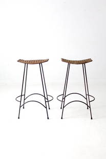 Vintage Arthur Umanoff Pair of Wicker Bar Stools with Iron Legs: Vintage Arthur Umanoff Pair of Wicker Bar Stools with Iron Legs This pair of mid 20th century bar stools showcases the iconic styling of Arthur Umanoff. Designed with modern aesthetics in mind, these