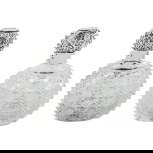 Pair of Sterling Silver and Crystal Perfume Bottles: Pair of Sterling Silver and Crystal Perfume Bottles This exquisite pair of sterling silver and crystal perfume bottles, crafted in England circa 1907, features an intricate cut-glass design complement