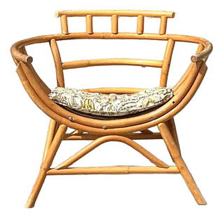 Vintage Rattan Lounge Chair with Botanical Cushion Coastal Charm: Vintage Rattan Lounge Chair with Botanical Cushion Coastal Charm Experience the essence of coastal living with this vintage bent rattan lounge chair. Crafted with a sculptural frame, it highlights the
