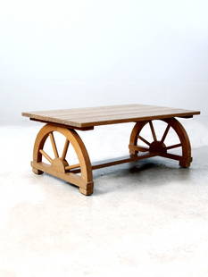 1940s Monterey Style Faux Bois Coffee Table with Wagon Wheel Legs: 1940s Monterey Style Faux Bois Coffee Table with Wagon Wheel Legs This vintage 1940s Monterey style coffee table showcases a rustic faux bois wood finish and a plank-style top, complemented by distinc