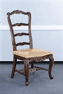 Elegant Tall French Side Chair in Distressed Walnut Finish: Elegant Tall French Side Chair in Distressed Walnut Finish This charming tall French side chair features exquisite carved details that enhance its country French style. Crafted from mahogany rattan an