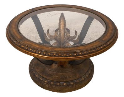 Ornate Round Coffee Table with Glass Top and Leather Edge: Ornate Round Coffee Table with Glass Top and Leather Edge This round decorative glass top coffee table features an ornate base with scrolled iron support. It has a tooled leather outer edge on the top