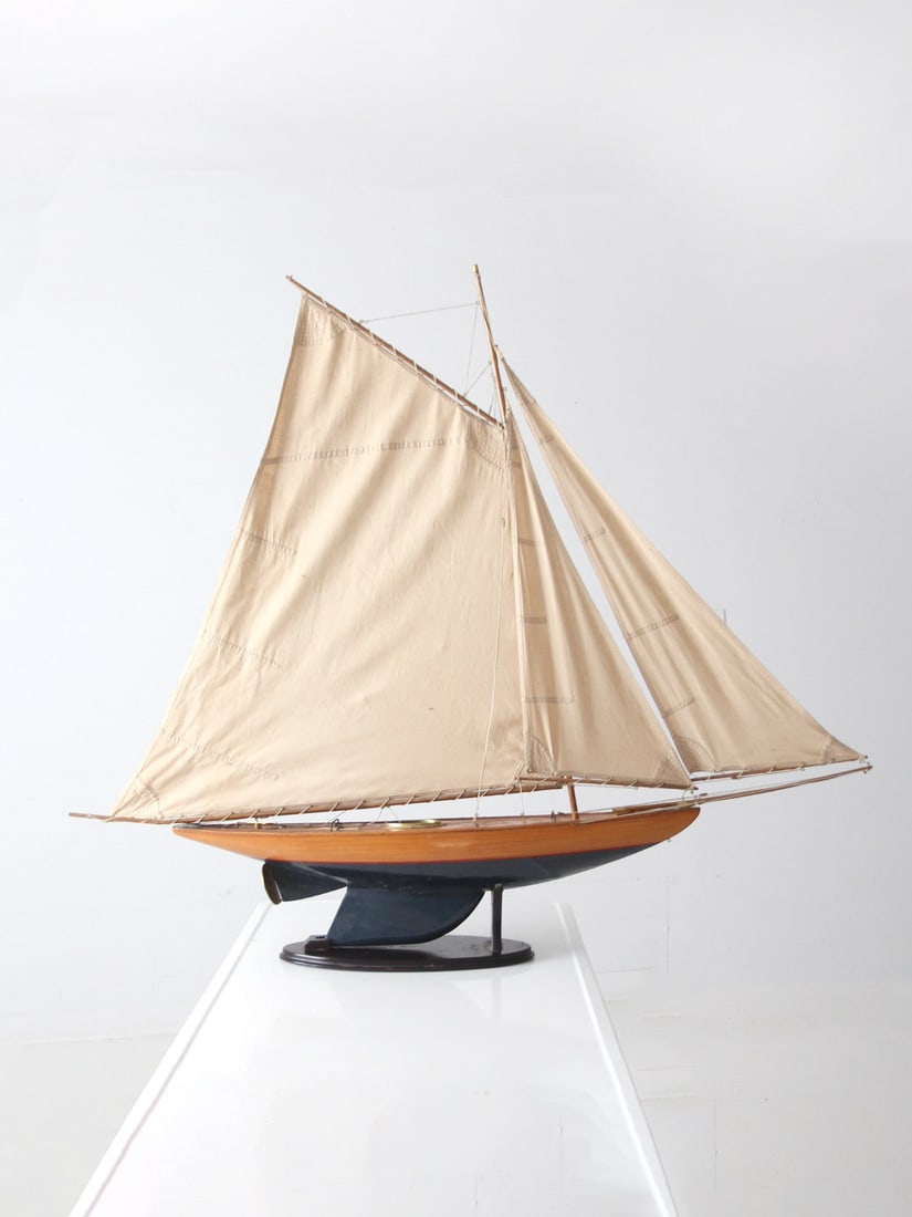 Vintage Gaff-Rigged Pond Yacht Model Circa 1930s to 1950s: Vintage Gaff-Rigged Pond Yacht Model Circa 1930s to 1950s This vintage pond yacht model, circa 1930s to 1950s, features a gaff-rigged sail plan with natural canvas sails, aged twine rigging, and metal