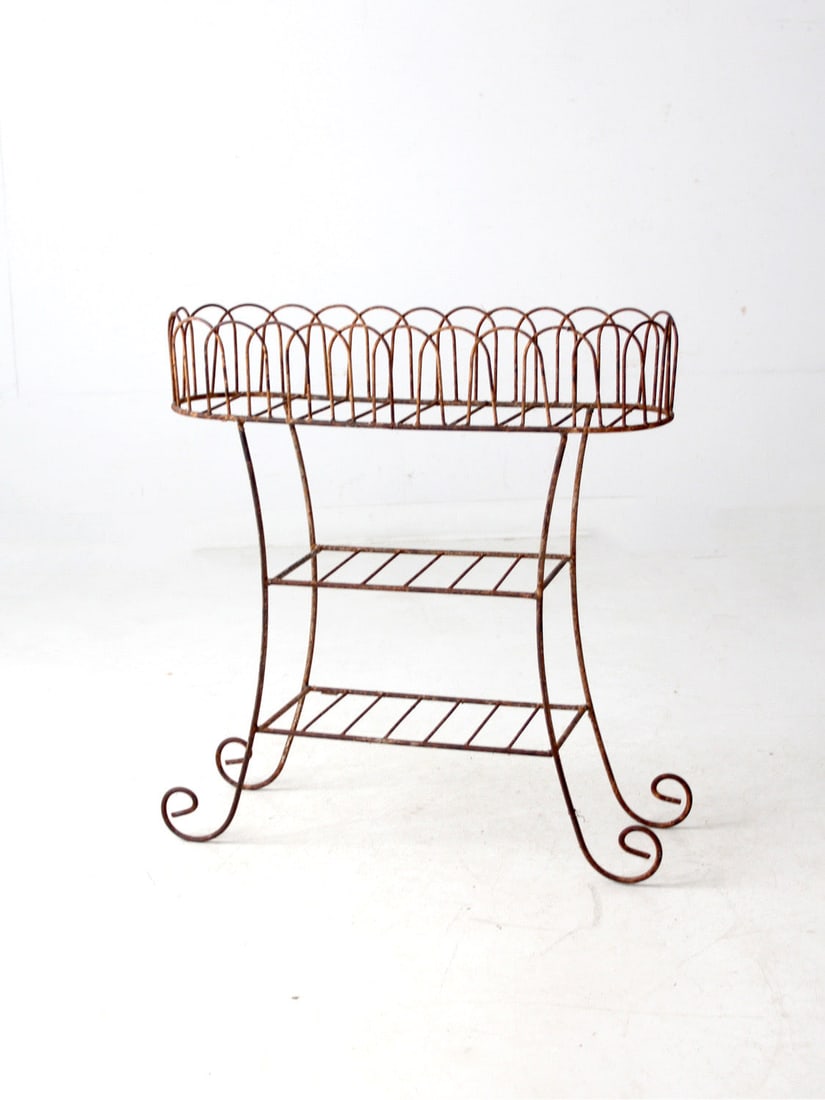 Vintage Wrought Iron Tiered Plant Stand with Decorative Basket: Vintage Wrought Iron Tiered Plant Stand with Decorative Basket Enhance your space with this vintage wrought iron plant stand, designed with a decorative top basket and two lower shelves, perfect for d