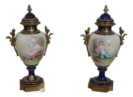 Vintage Pair of Sevres Porcelain Lidded Urns with Bronze Trim: Vintage Pair of Sevres Porcelain Lidded Urns with Bronze Trim This exquisite pair of vintage Sevres porcelain lidded urns, dating from the 1930s, showcases beautiful blue and white hand-painted detail