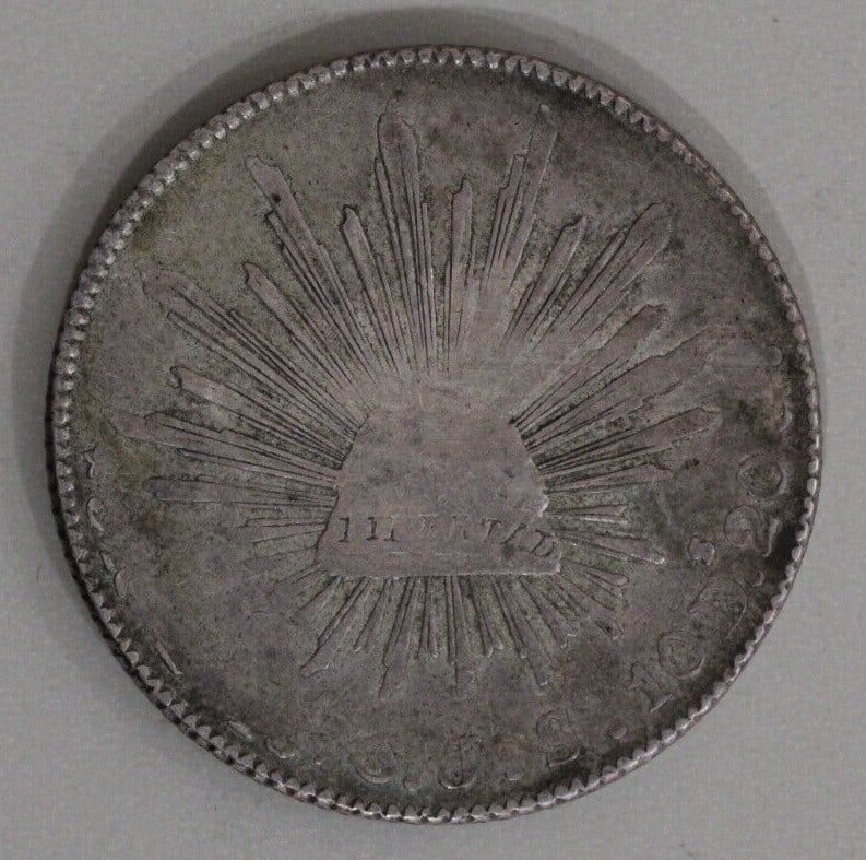 Mexico 1876-Zs Cap and Ray 8 Reales Silver Coin Zacatecas Mint: Mexico 1876-Zs Cap and Ray 8 Reales Silver Coin Zacatecas Mint This historical Mexico 1876-Zs Cap and Ray 8 Reales coin, minted at the Zacatecas Mint, is a remarkable piece of silver currency. Crafted