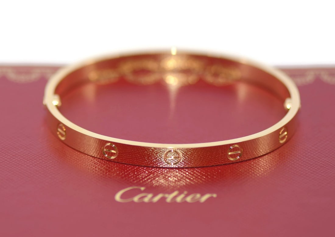 Cartier 18K Yellow Gold Love Bracelet Size 19 with Box and Certificate: Cartier 18K Yellow Gold Love Bracelet Size 19 with Box and Certificate This exquisite 18K Yellow Gold Love Bracelet from Cartier embodies timeless elegance and sophistication. Designed in a classic ba