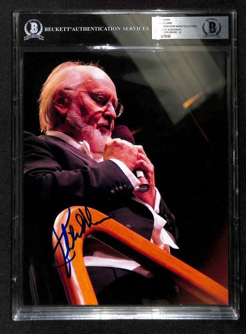 John Williams Signed 8x10 Photo Authenticated by Beckett: John Williams Signed 8x10 Photo Authenticated by Beckett This 8x10 photograph features the autograph of renowned composer John Williams, known for his iconic film scores. Signed in blue permanent mark