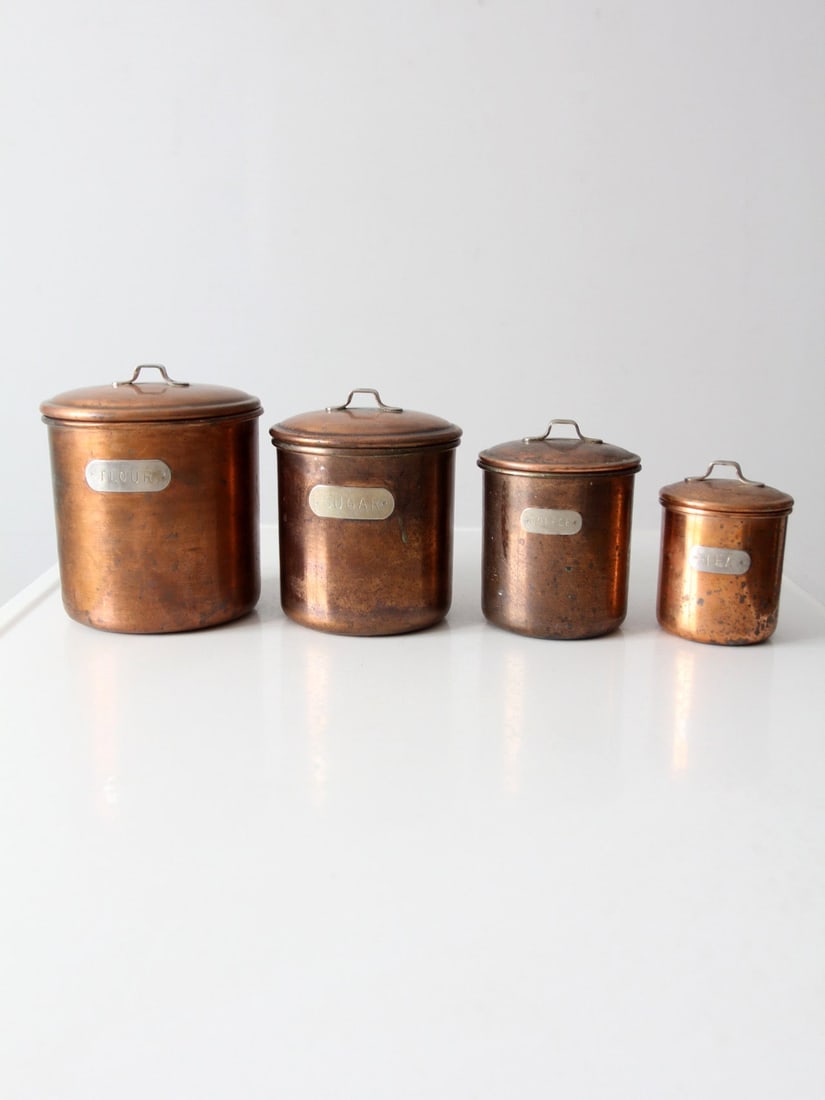 Charming Vintage Copper Canisters Set of 4 with Labeled Lids: Charming Vintage Copper Canisters Set of 4 with Labeled Lids Enhance your kitchen decor with this charming Vintage Copper Kitchen Canisters Set of 4. Each canister is complete with a handled lid and a
