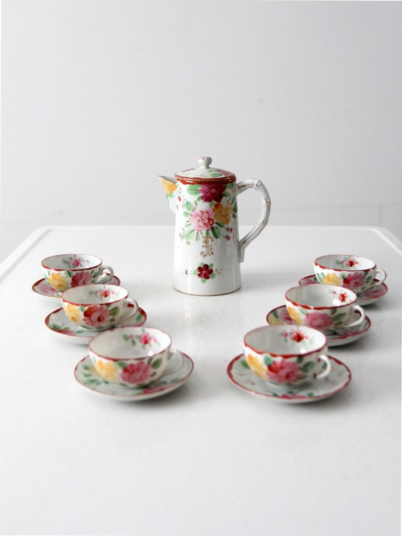 Antique Japanese 13 Piece Tea Set with Floral Design: Antique Japanese 13 Piece Tea Set with Floral Design This is an antique Japanese tea set. The "eggshell" porcelain set includes a tea pot and six tea cups with saucers. A lovely pink floral pattern de