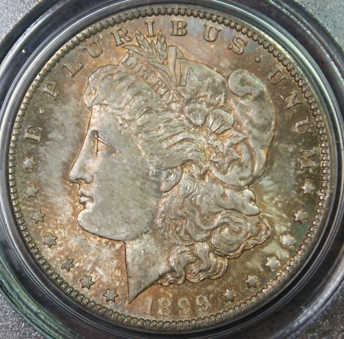 1899-O Morgan Silver Dollar Coin PCGS MS-64 Toned Uncirculated: 1899-O Morgan Silver Dollar Coin PCGS MS-64 Toned Uncirculated This 1899-O Morgan Silver Dollar Coin is a stunning piece from the New Orleans Mint, showcasing its unique toning and an uncirculated con