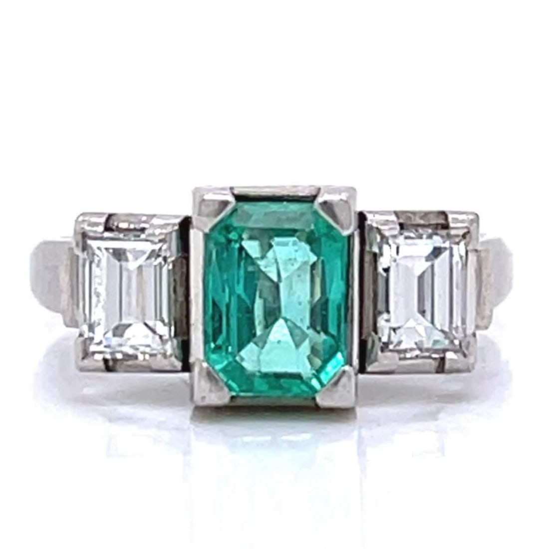 Stunning Platinum 1.03 Ct Emerald & 0.55 Ct Diamond Ring: Stunning Platinum 1.03 Ct Emerald & 0.55 Ct Diamond Ring This exquisite ring features a stunning 1.03 Ct. emerald, beautifully complemented by two diamonds with a total weight of approximately 0.55 Ct