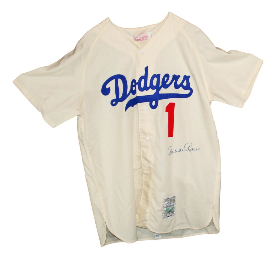Pee Wee Reese Autographed Mitchell & Ness Dodgers Jersey PSA/DNA: Pee Wee Reese Autographed Mitchell & Ness Dodgers Jersey PSA/DNA This is an authentic Mitchell & Ness jersey of the legendary Pee Wee Reese, a prominent player of the Brooklyn Dodgers. The jersey is p