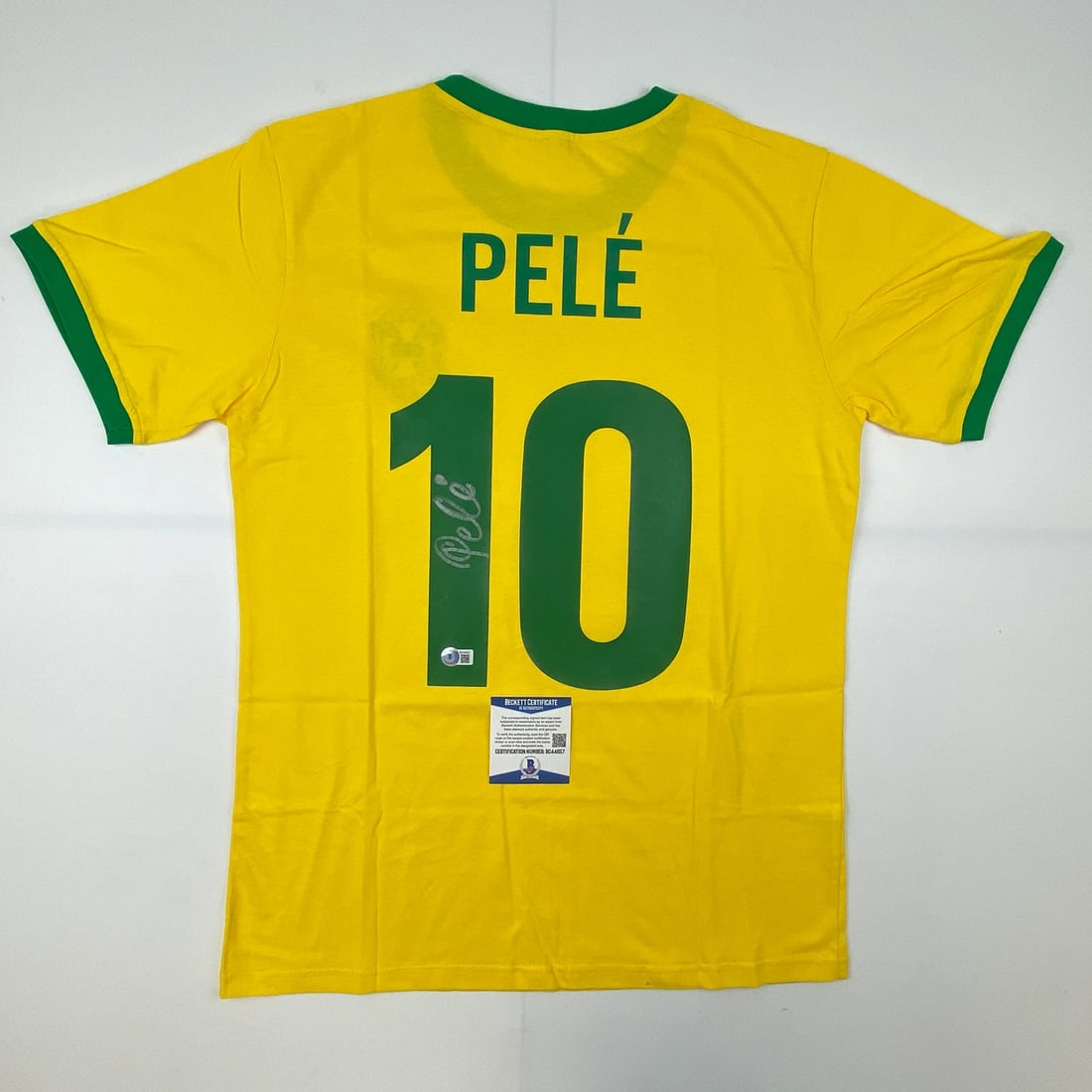 Pele Signed Brazil Yellow Soccer Jersey with Beckett COA: Pele Signed Brazil Yellow Soccer Jersey with Beckett COA This is an authentic autographed Brazil yellow soccer jersey signed by the legendary athlete Pele. The jersey comes with a Certificate of Authe