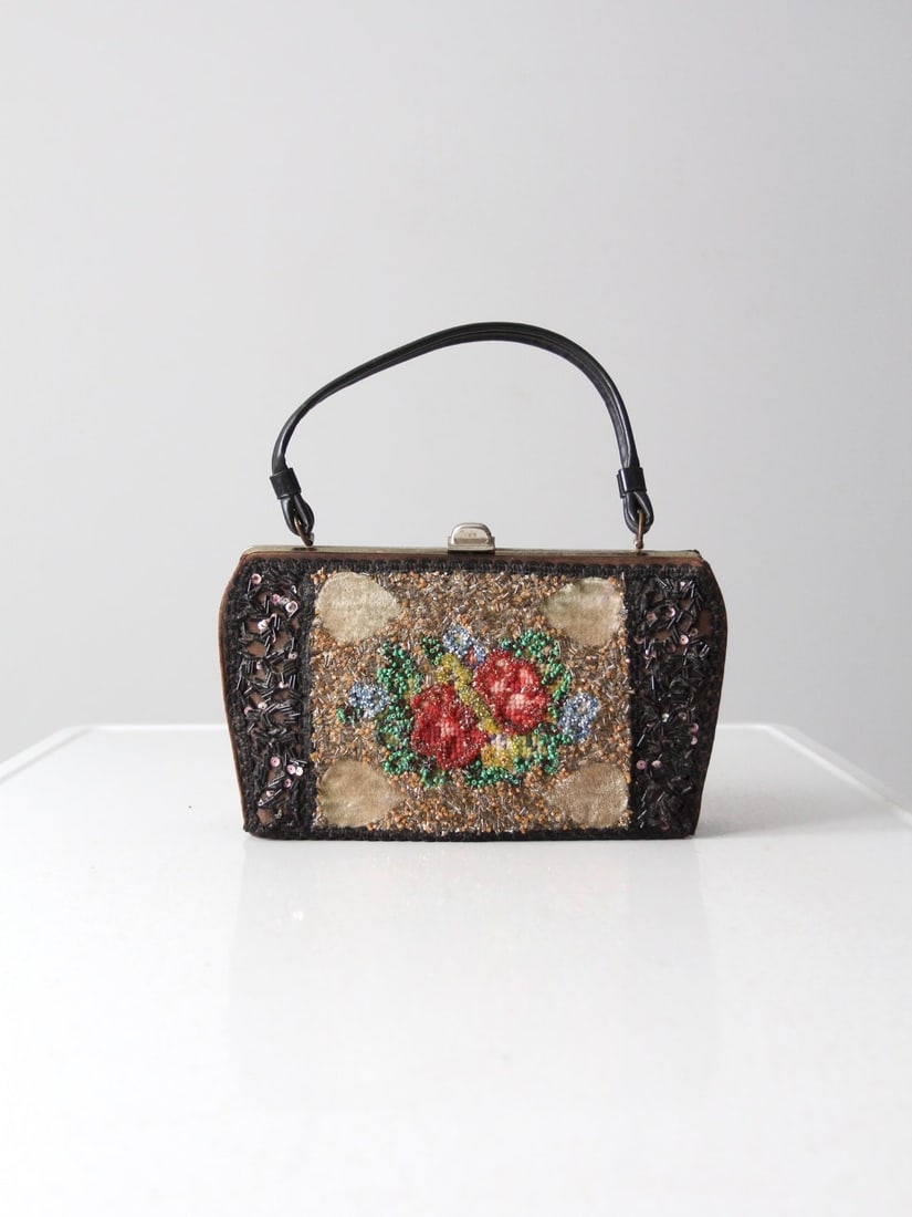 1960s Caron of Houston Floral Beaded Purse with Leather Handle: 1960s Caron of Houston Floral Beaded Purse with Leather Handle Step back in time with this exquisite 1960s vintage Caron of Houston purse. This hand-decorated bag boasts a chic frame top design featur