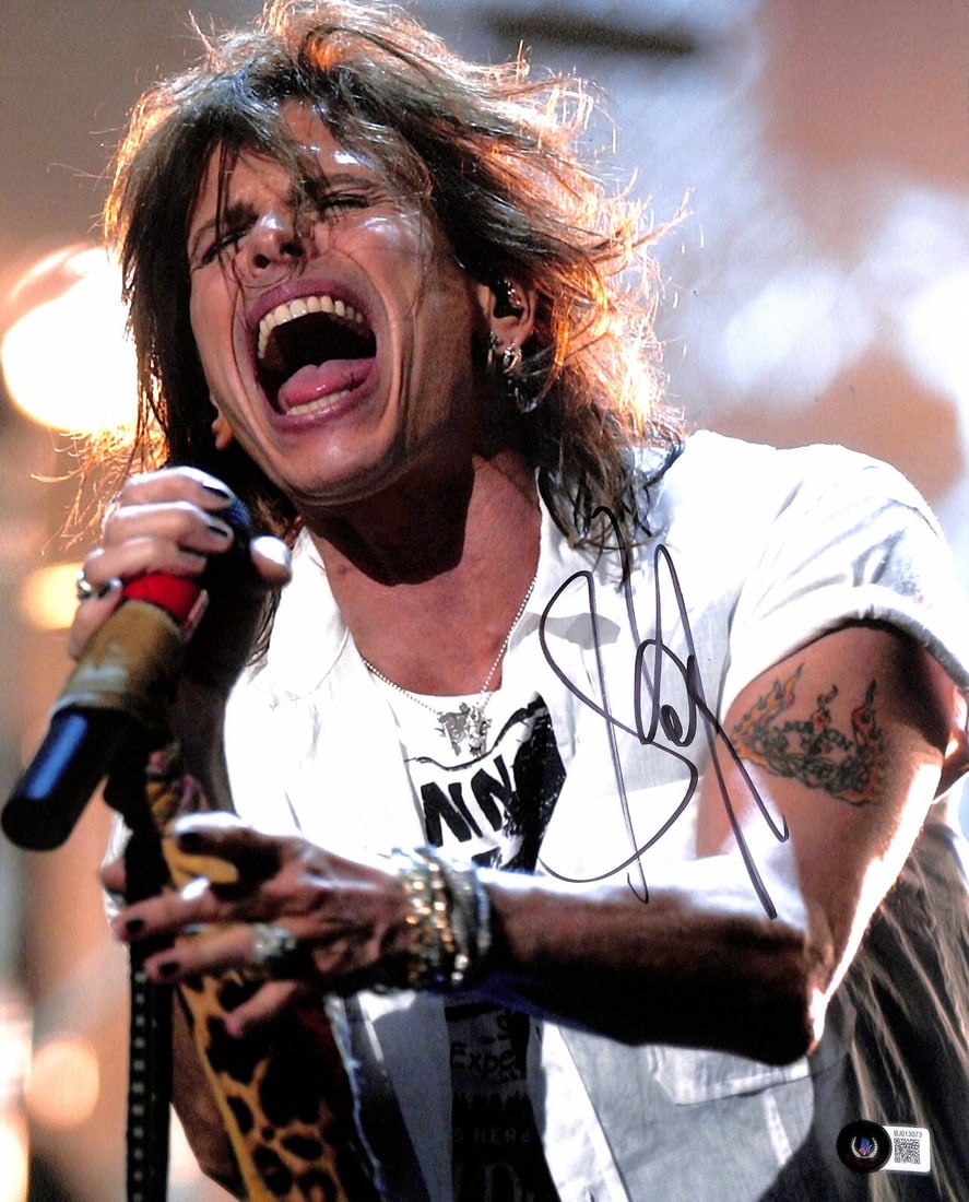 Aerosmith Steven Tyler Autographed 11x14 Photo Beckett Certified: Aerosmith Steven Tyler Autographed 11x14 Photo Beckett Certified This stunning 11x14 color photograph captures Aerosmith frontman Steven Tyler in a moment of rock brilliance. The photo is autographed 