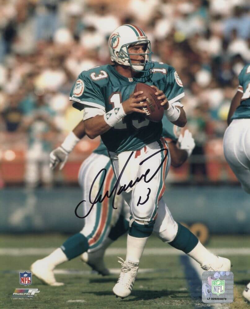 Dan Marino Signed Dolphins Teal Jersey Action 8x10 Photo with COA: Dan Marino Signed Dolphins Teal Jersey Action 8x10 Photo with COA This is a signed 8x10 action photo of Dan Marino in his Miami Dolphins dropback teal jersey. The photo captures Marino, a legendary NF