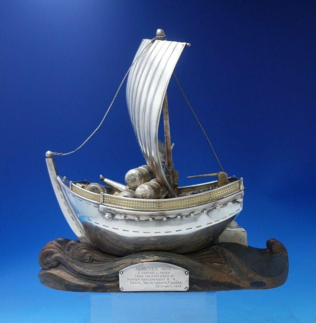 Japanese .950 Silver Ship Sculpture with Faux Gold Barrels: Japanese .950 Silver Ship Sculpture with Faux Gold Barrels This exquisite Japanese sculpture captures the elegance of a ship with its sail, crafted from .950 silver. The ship features faux gold barrel