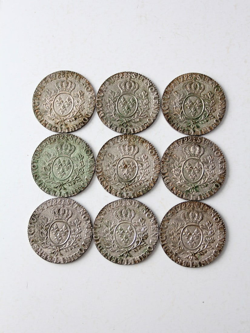 Vintage 1788 Louis XVI Coin Coaster Set of 9 Silver Tone: Vintage 1788 Louis XVI Coin Coaster Set of 9 Silver Tone This exquisite set features nine vintage replica Louis XVI 1788 Sit Nomen Domini Benedictum coin coasters, each showcasing the backside of the
