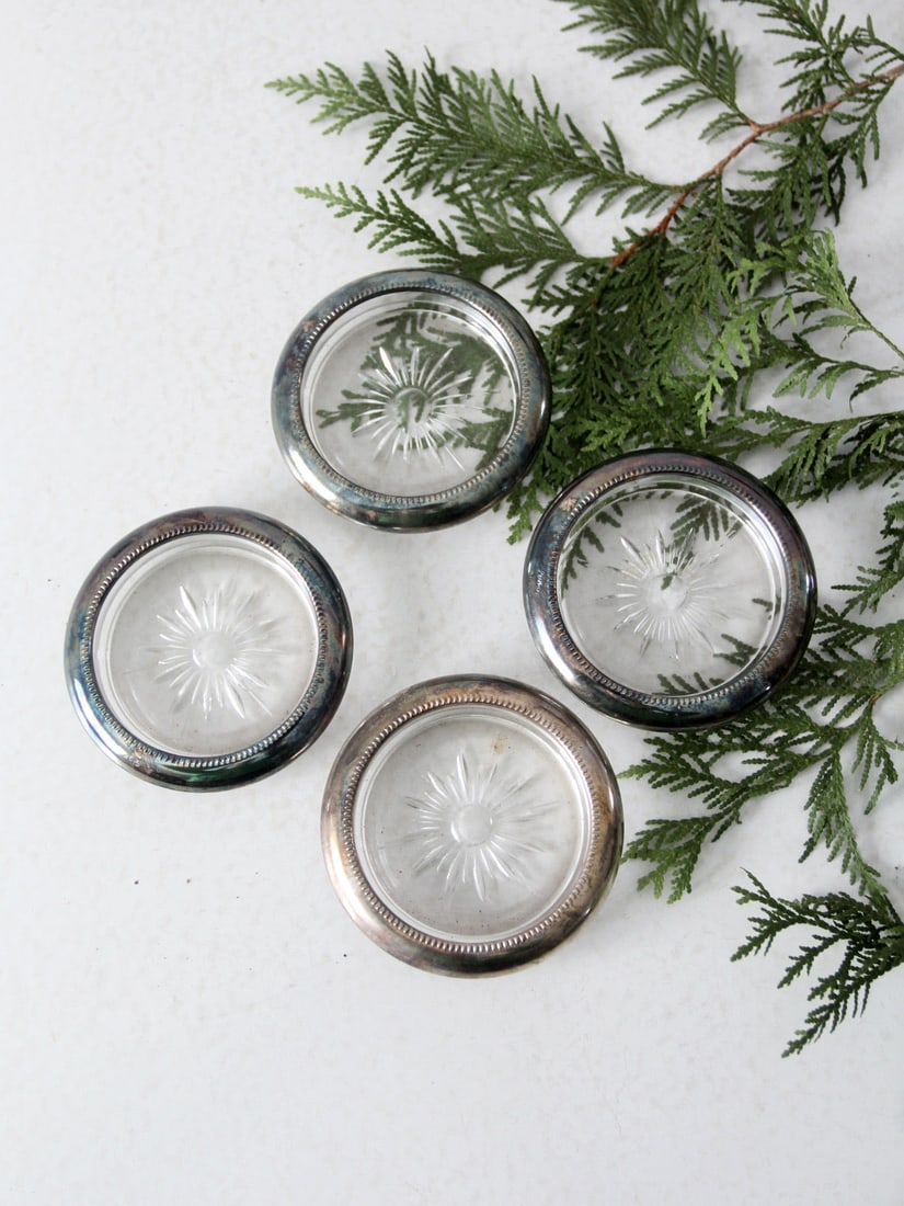 Mid-Century Leonard Silver Plate Coasters Set of 4 with Sunburst Design: Mid-Century Leonard Silver Plate Coasters Set of 4 with Sunburst Design Enhance your home decor with this elegant set of four mid-century Leonard glass coasters. Each coaster features a stunning cut s