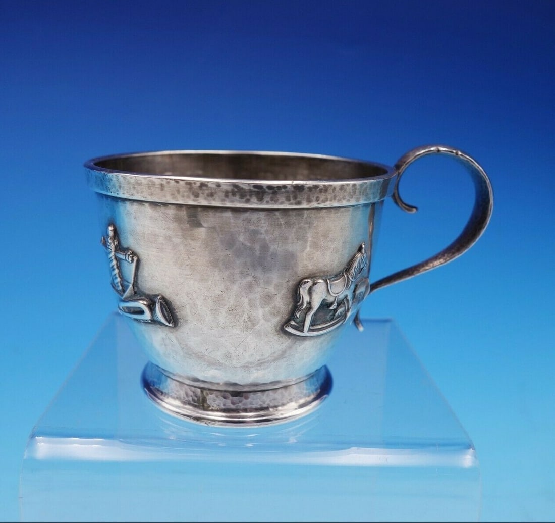 Whiting Sterling Silver Baby Cup Hand Hammered with Toy Motifs 1924: Whiting Sterling Silver Baby Cup Hand Hammered with Toy Motifs 1924 This charming Whiting sterling silver baby cup showcases exquisite craftsmanship with its hand-hammered finish and delightful applie