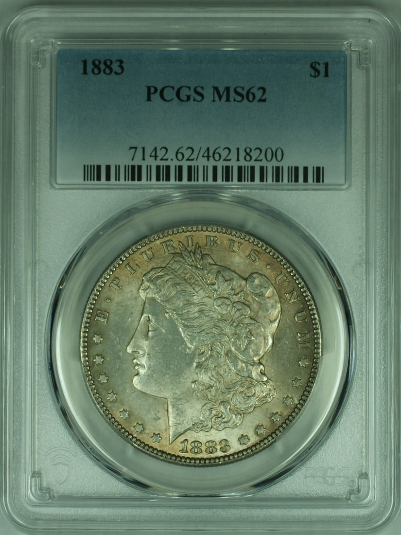 1883 Morgan Silver Dollar Coin PCGS MS62 Uncirculated Silver: 1883 Morgan Silver Dollar Coin PCGS MS62 Uncirculated Silver This 1883 Morgan Silver Dollar Coin is a remarkable addition to any collection. It features a denomination of $1 and is classified as uncir