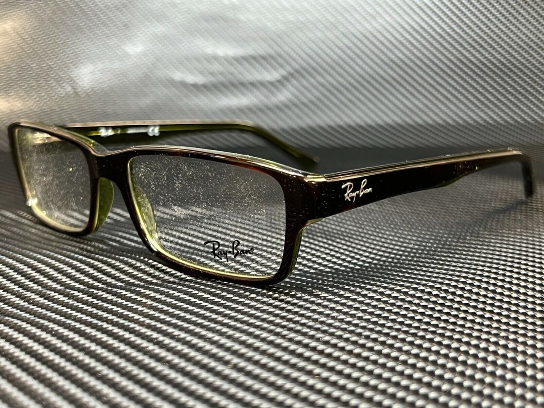 Ray-Ban RX5169 2383 Havana Green Unisex Eyeglasses with Case: Ray-Ban RX5169 2383 Havana Green Unisex Eyeglasses with Case Discover the stylish and functional Ray-Ban RX5169 2383 eyeglasses, designed for both men and women. The frame features a chic Havana Green