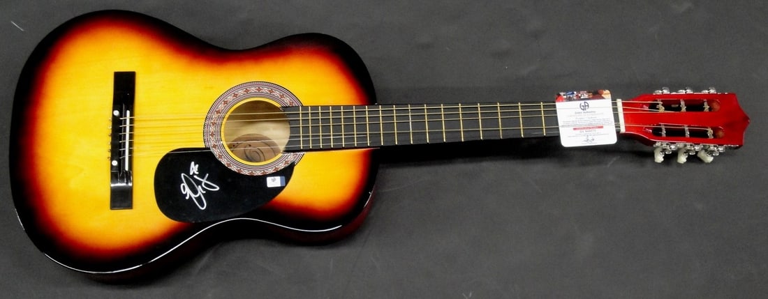 Elle King Autographed Acoustic Guitar 38" GAI Certified: Elle King Autographed Acoustic Guitar 38" GAI Certified This is a genuine Elle King hand-signed autographed acoustic guitar, measuring 38 inches. The guitar has been authenticated by Global Authentics