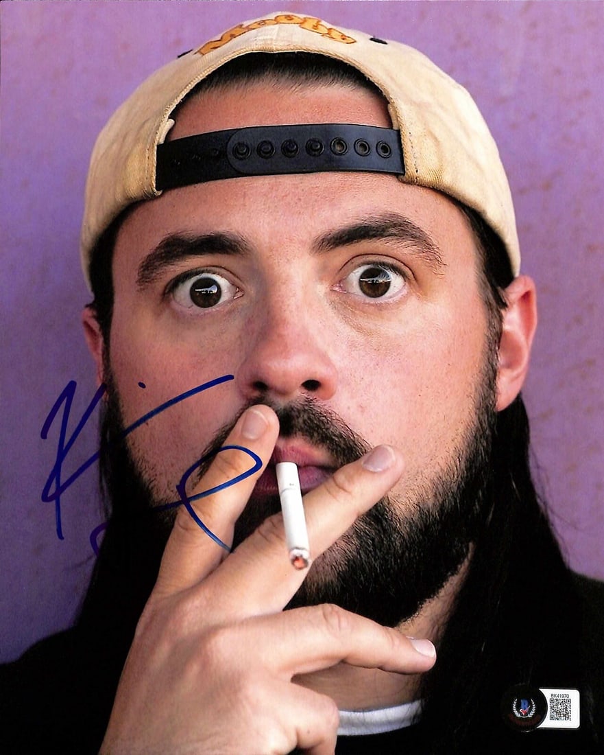 Kevin Smith Signed Clerks II 8x10 Photo Beckett Certified: Kevin Smith Signed Clerks II 8x10 Photo Beckett Certified This is an autographed 8X10 photograph featuring Kevin Smith from the movie Clerks II, signed in blue permanent marker. The signature is authe