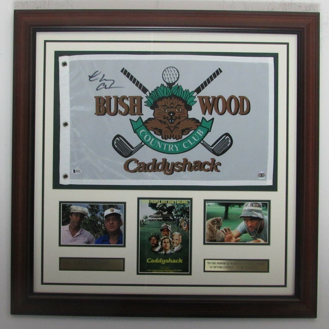 Chevy Chase Caddyshack Signed Pin Flag Photo Collage Framed BAS Beckett: Chevy Chase Caddyshack Signed Pin Flag Photo Collage Framed BAS Beckett This is a framed collage featuring a signed pin flag of Chevy Chase from the classic film "Caddyshack." The item is authenticate