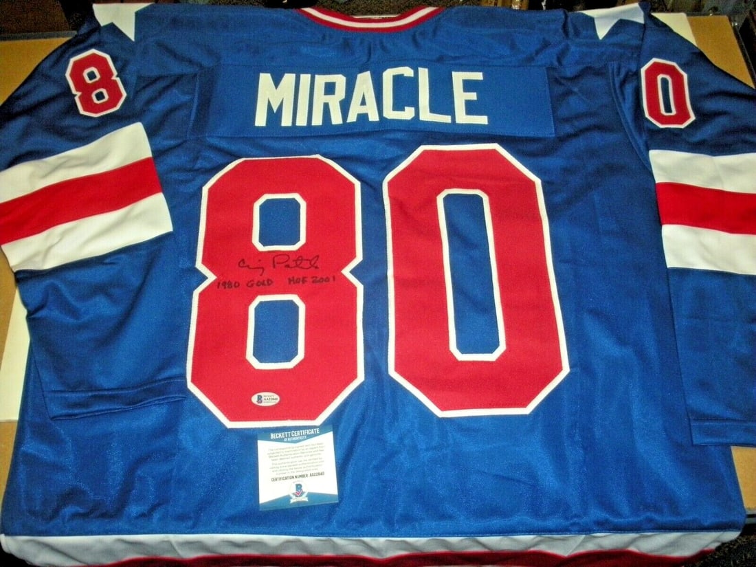 Craig Patrick Signed 1980 Olympic Gold Medal Jersey with Beckett COA: Craig Patrick Signed 1980 Olympic Gold Medal Jersey with Beckett COA This is an original signed jersey commemorating Craig Patrick's achievement as a member of the 1980 Olympic Gold Medal-winning hock
