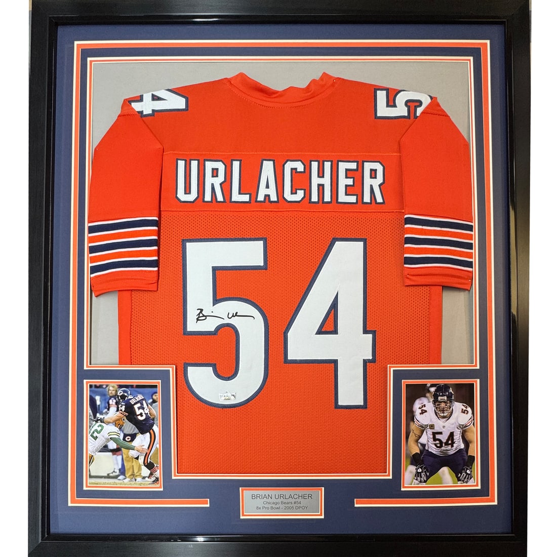 Framed Brian Urlacher Jersey Reprint 33x42 JSA Authenticated: Framed Brian Urlacher Jersey Reprint 33x42 JSA Authenticated This item features a framed facsimile of Brian Urlacher's autograph on a vibrant orange jersey, measuring 33x42 inches. It is a reprint tha
