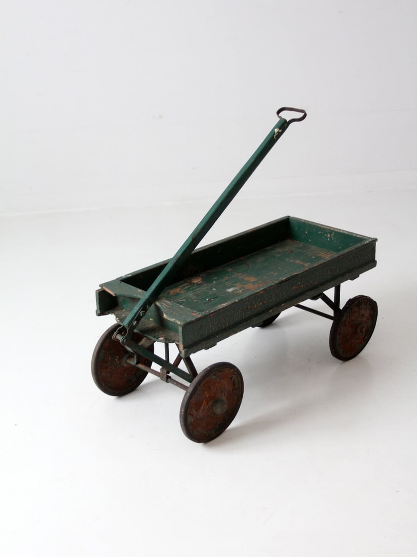Charming Antique Wooden Coaster Wagon Green Early 20th Century: Charming Antique Wooden Coaster Wagon Green Early 20th Century Explore this charming antique wooden wagon, a delightful piece from the early 20th century. This coaster-style green pull cart showcases
