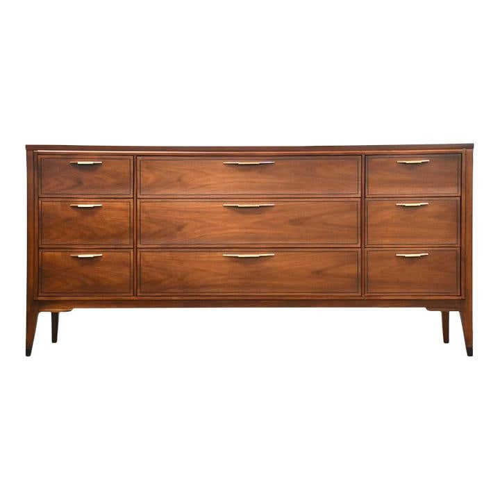 Mid Century Kent Coffey Tempo Walnut Dresser 9 Drawers: Mid Century Kent Coffey Tempo Walnut Dresser 9 Drawers This stunning mid-century modern dresser is crafted from rich walnut, featuring nine spacious drawers for ample storage. The dresser, made by Ken