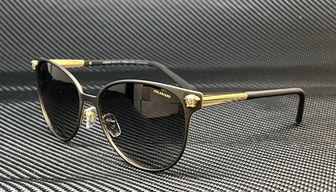 Versace VE2168 1377T3 Black Gold Polarized Sunglasses 57mm: Versace VE2168 1377T3 Black Gold Polarized Sunglasses 57mm Elevate your accessory collection with these luxurious Versace VE2168 1377T3 women's polarized sunglasses. Featuring a striking black and gol