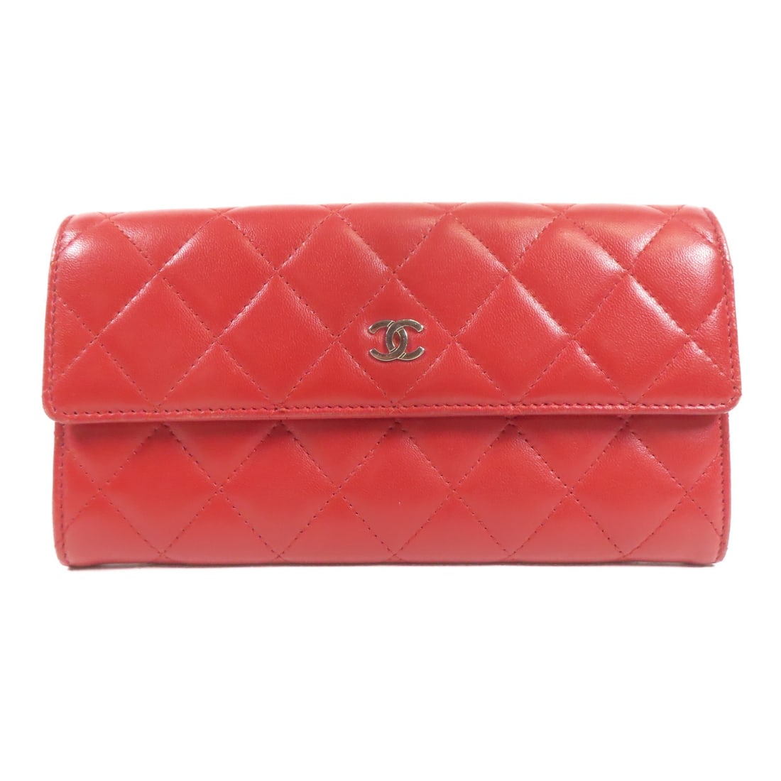 CHANEL Red Lambskin Bifold Wallet with SHW: CHANEL Red Lambskin Bifold Wallet with SHW This elegant CHANEL long wallet features a classic bifold design crafted from luxurious red lambskin leather, known for its softness and durability. The wall