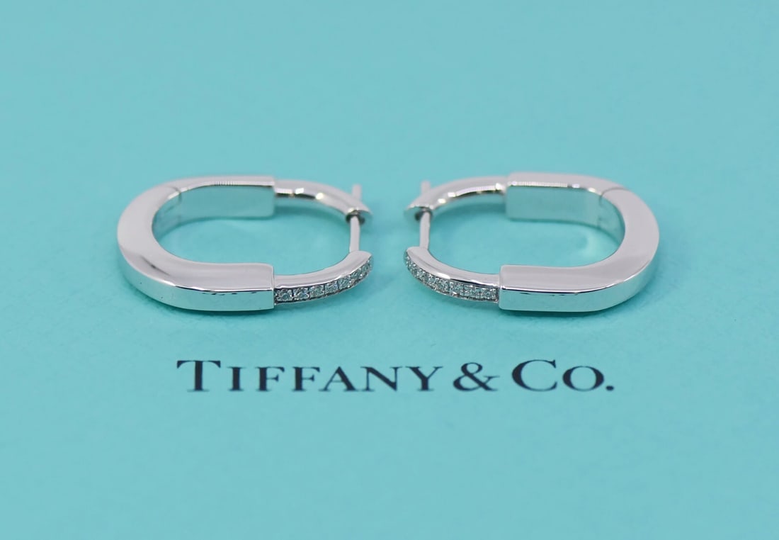 Tiffany & Co 18K White Gold Diamond Hoop Earrings Small: Tiffany & Co 18K White Gold Diamond Hoop Earrings Small Elevate your accessory collection with these exquisite Tiffany & Co. Lock Diamond Earrings, crafted from luxurious 18K white gold. These small h