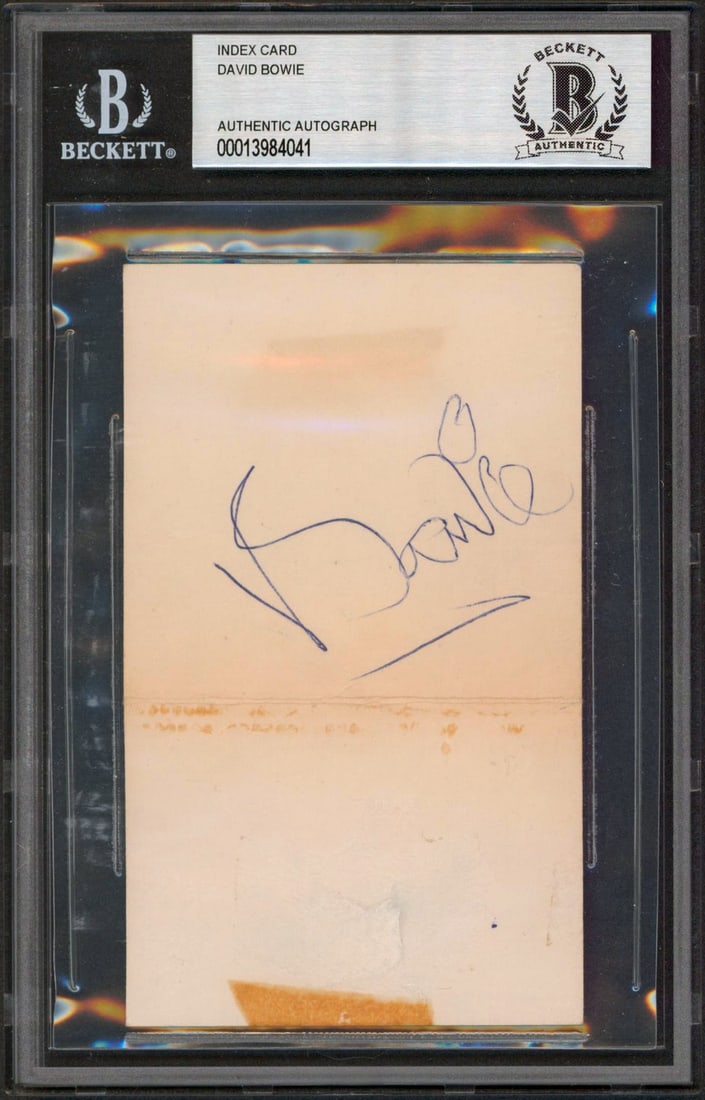 David Bowie Signed 3x5 Index Card Authenticated by Beckett: David Bowie Signed 3x5 Index Card Authenticated by Beckett This authentic 3x5 index card features the signature of the legendary David Bowie, personally signed and verified. It comes slabbed and authe