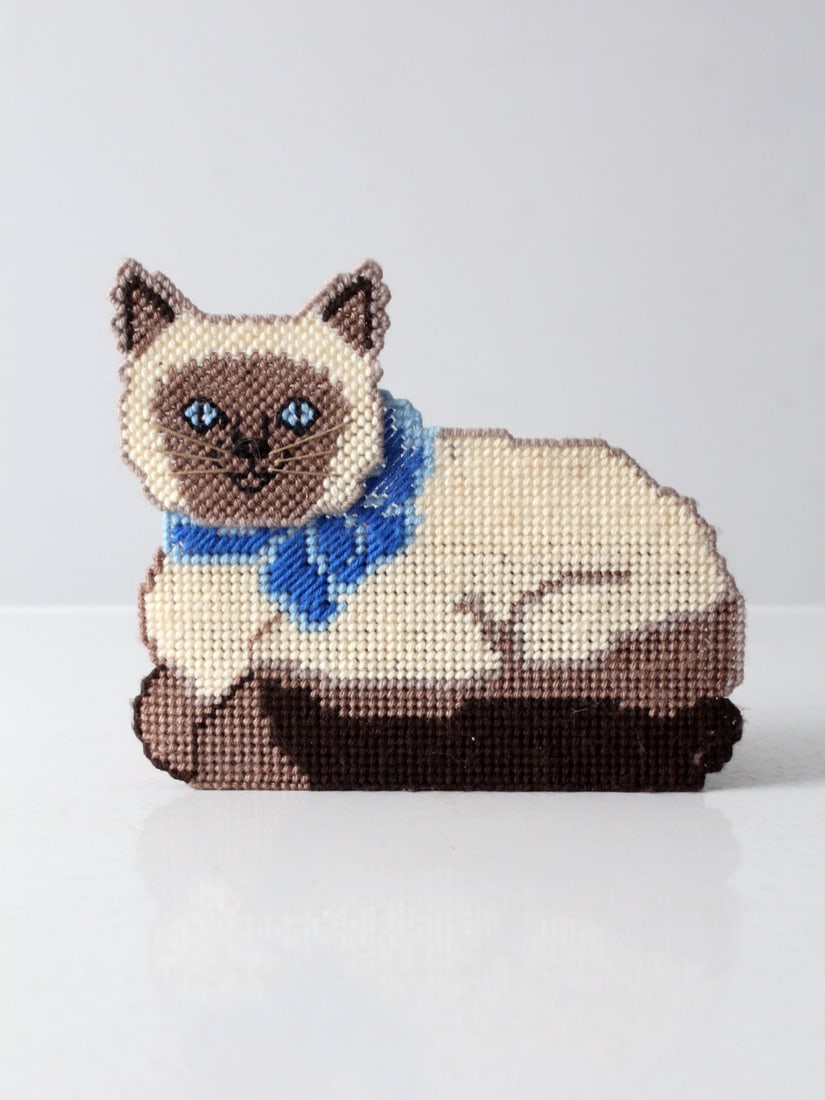 Charming Vintage Needlepoint Siamese Cat Doorstop: Charming Vintage Needlepoint Siamese Cat Doorstop Add a whimsical touch to your home with this vintage needlepoint doorstop featuring a charming Siamese cat design. Handcrafted with intricate needlepo