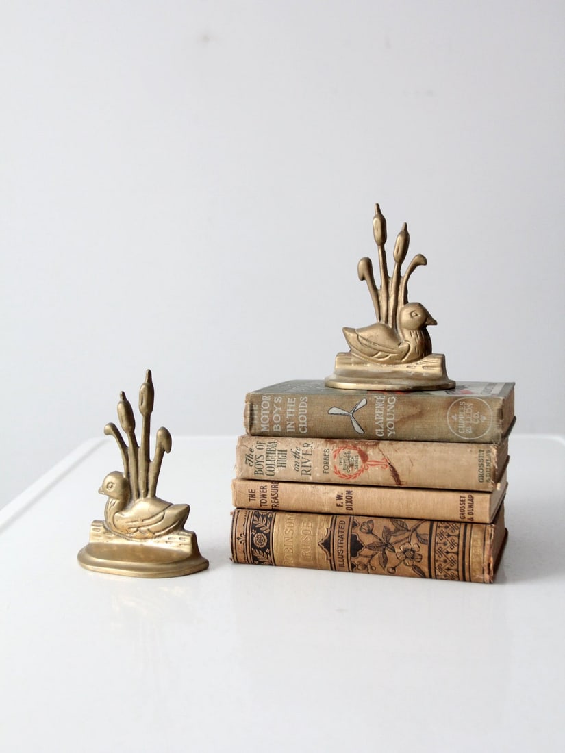 Vintage Brass Duckling Bookends Pair Decorative Accent: Vintage Brass Duckling Bookends Pair Decorative Accent Enhance your home or office with this charming pair of vintage brass duck bookends. Featuring a delightful duckling design complemented by cattai