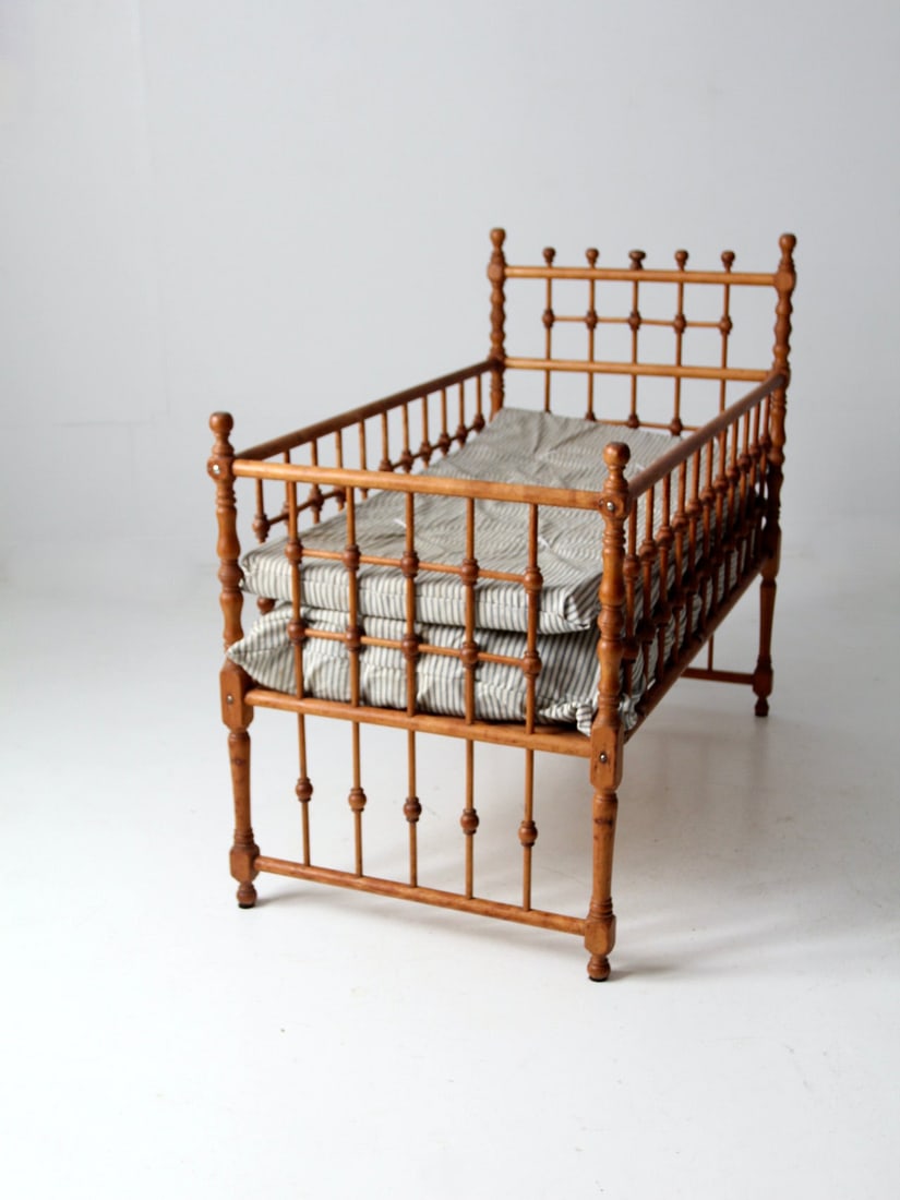 Victorian Antique Wooden Frame Bed with Ticking Cushion: Victorian Antique Wooden Frame Bed with Ticking Cushion Step back in time with this exquisite Antique Victorian Wooden Frame Bed, dating back to the late 19th century. This bed showcases a raised desi