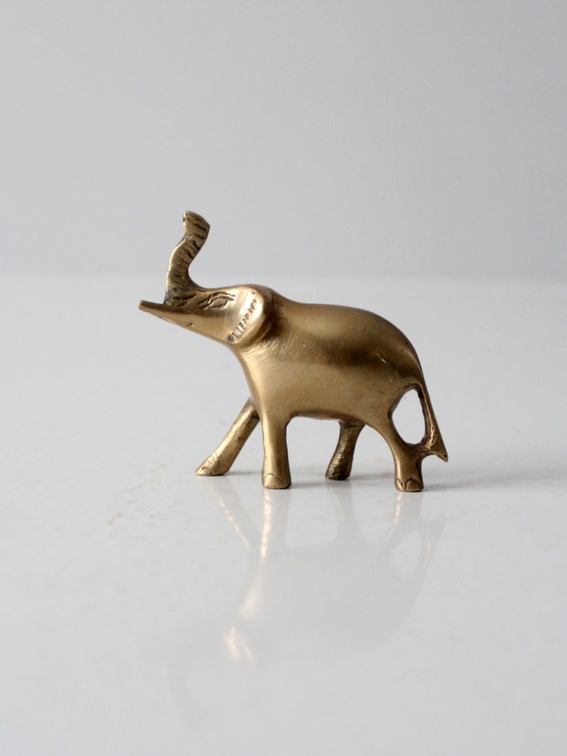 Vintage Mid Century Brass Elephant Decorative Paperweight: Vintage Mid Century Brass Elephant Decorative Paperweight This vintage mid 20th century brass elephant features a charming design with its trunk raised, symbolizing good luck. Ideal as a decorative sh
