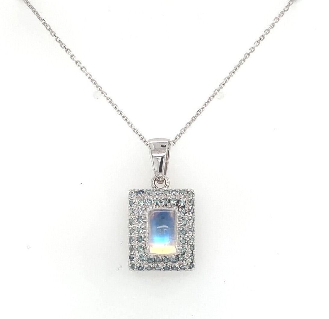 14k White Gold Moonstone Teal Sapphire Pendant Necklace GIA Certified: 14k White Gold Moonstone Teal Sapphire Pendant Necklace GIA Certified This stunning pendant necklace showcases a vibrant combination of a genuine natural moonstone and teal sapphires, elegantly set in