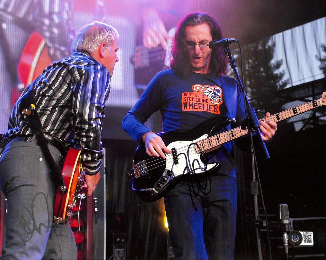 Rush Signed 11x14 Photo by Geddy Lee & Alex Lifeson Beckett Authenticated: Rush Signed 11x14 Photo by Geddy Lee & Alex Lifeson Beckett Authenticated This stunning 11x14 color photograph captures Geddy Lee and Alex Lifeson of the legendary rock band Rush, both of whom have si