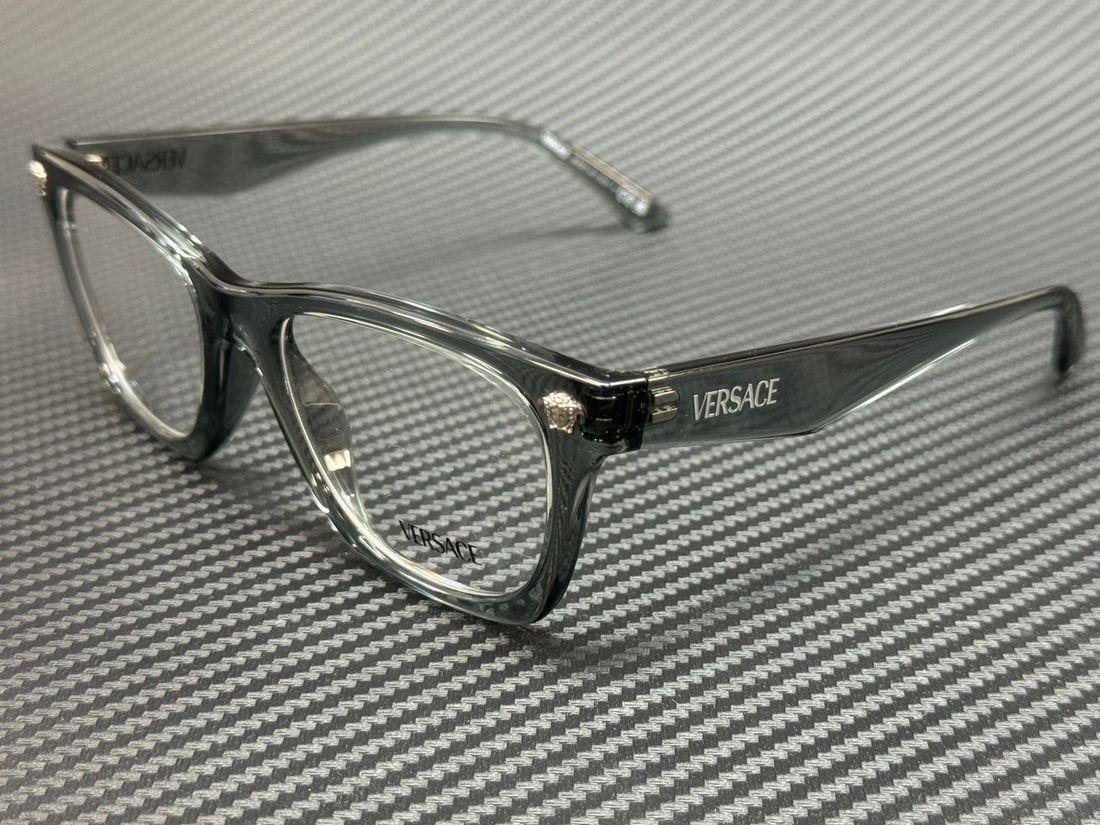 Versace VE3363U 5496 Gray Transparent 52mm Men's Eyeglasses with Authenticity Certificate: Versace VE3363U 5496 Gray Transparent 52mm Men's Eyeglasses with Authenticity Certificate Discover the elegance of Versace with these VE3363U 5496 eyeglasses. Featuring a stylish gray transparent fram