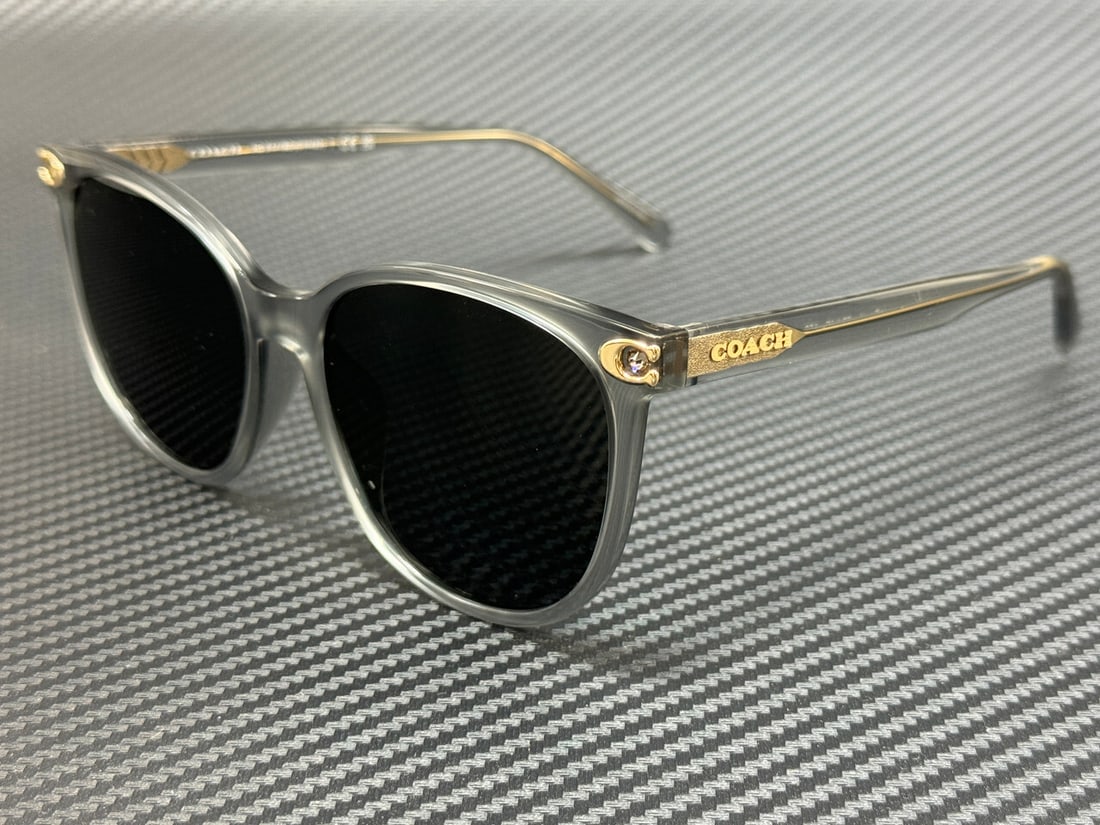 Coach HC8414BD 561487 Transparent Grey Women's Sunglasses 57mm: Coach HC8414BD 561487 Transparent Grey Women's Sunglasses 57mm Introducing the Coach HC8414BD 561487 Transparent Grey Women's Sunglasses, designed for style and comfort. These sunglasses feature a tra
